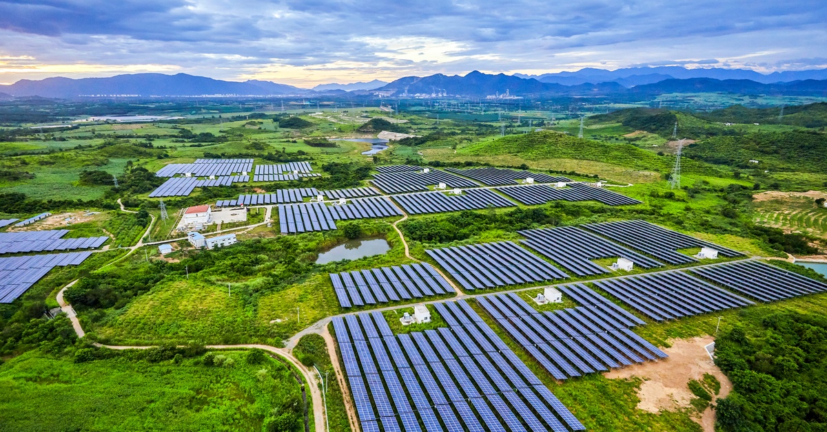 How Solar Lighting Contributes to a Climate-Resilient Future A solar farm with panels spread out among multiple spaces, separated by various trees and roads between everything.